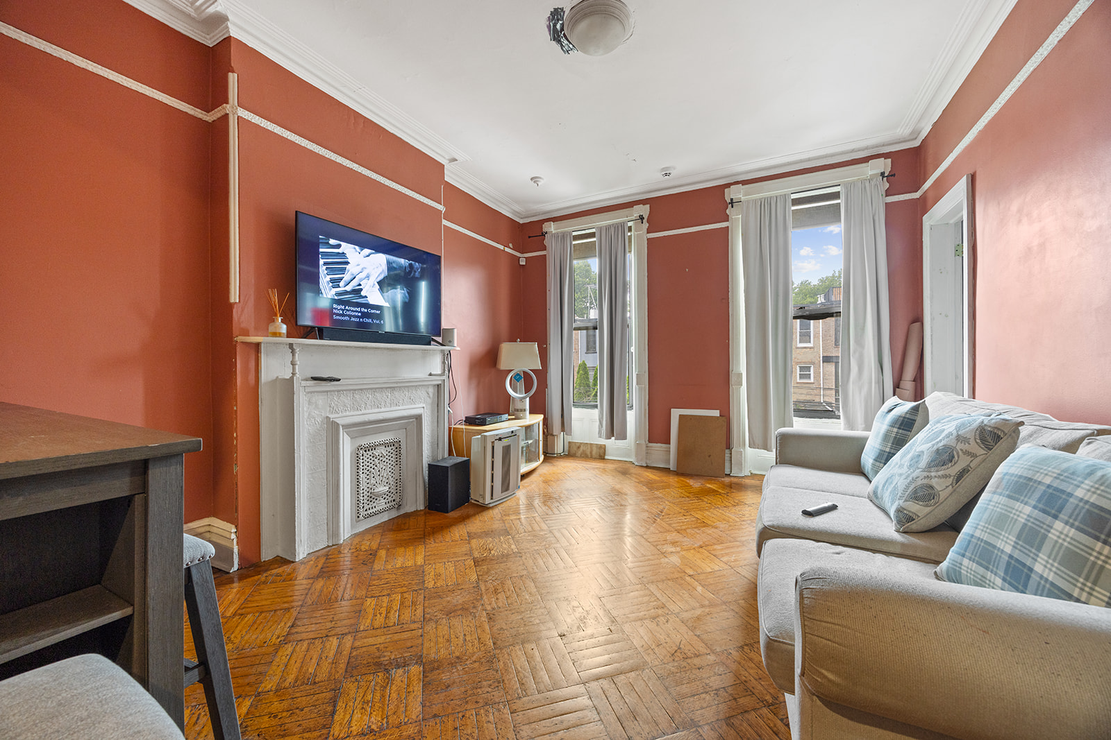621 Putnam Avenue Brooklyn, NY 11221 - Photo 10 of 17 a living room with furniture a fireplace and a flat screen tv