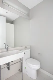 a bathroom with a sink a toilet and mirror