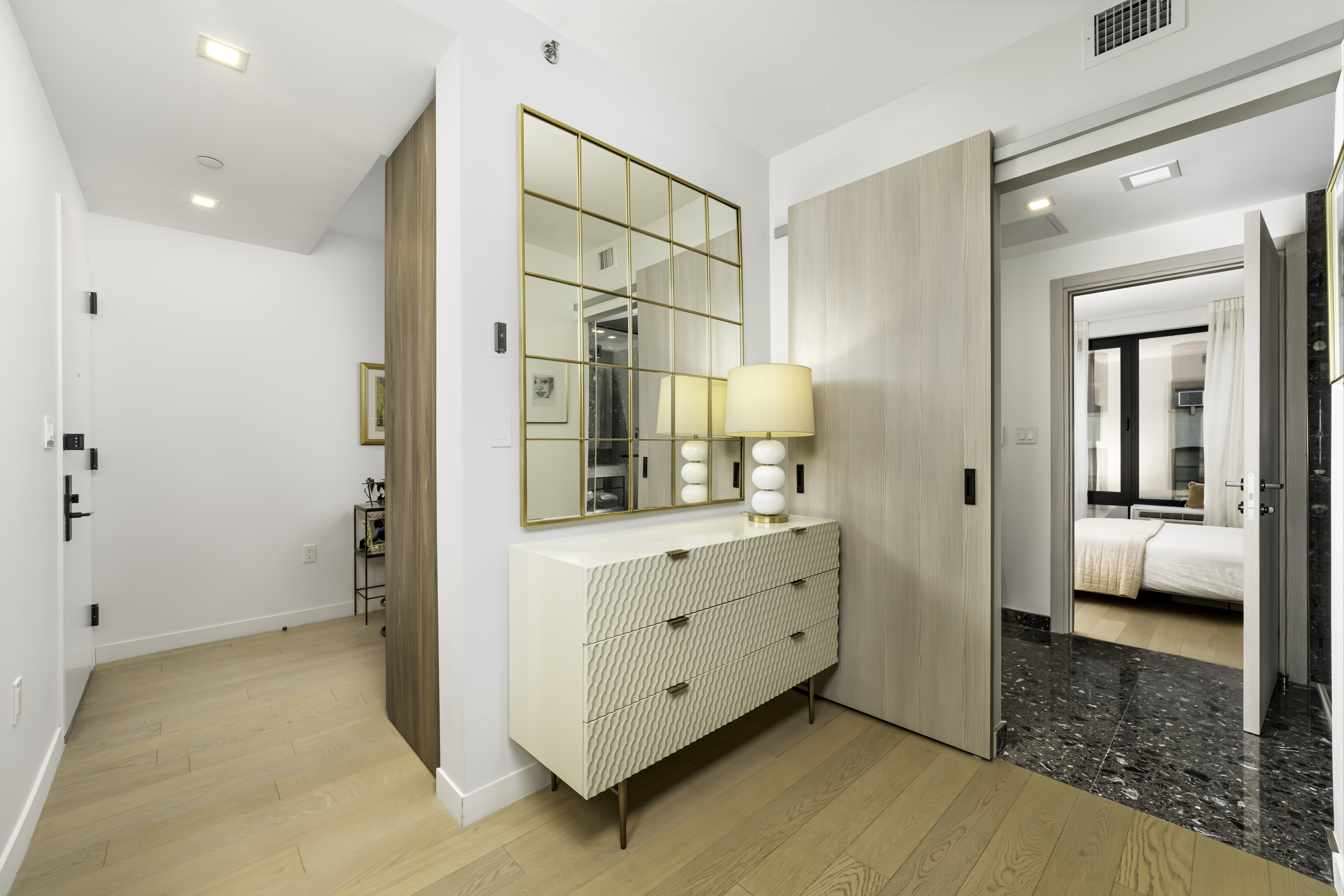 181 East 101st Street, Unit 701 Manhattan, NY 10029 - Photo 7 of 16 a room with a dresser and mirror