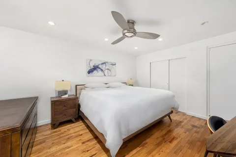 a bedroom with a bed and cabinets