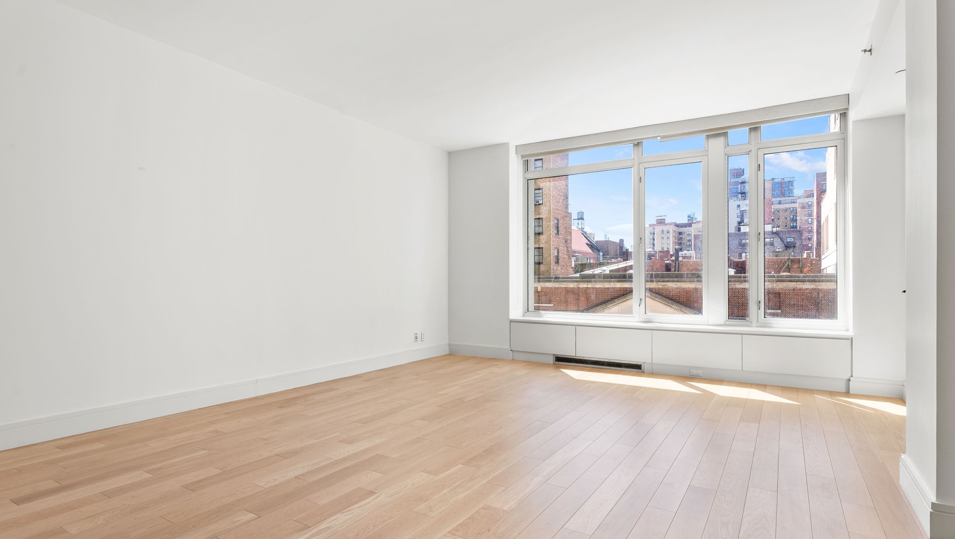 545 West 110th Street, Unit 5A Manhattan, NY 10025 - Photo 15 of 20 an empty room with wooden floor and windows