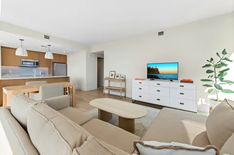 a living room with furniture a lamp and a table