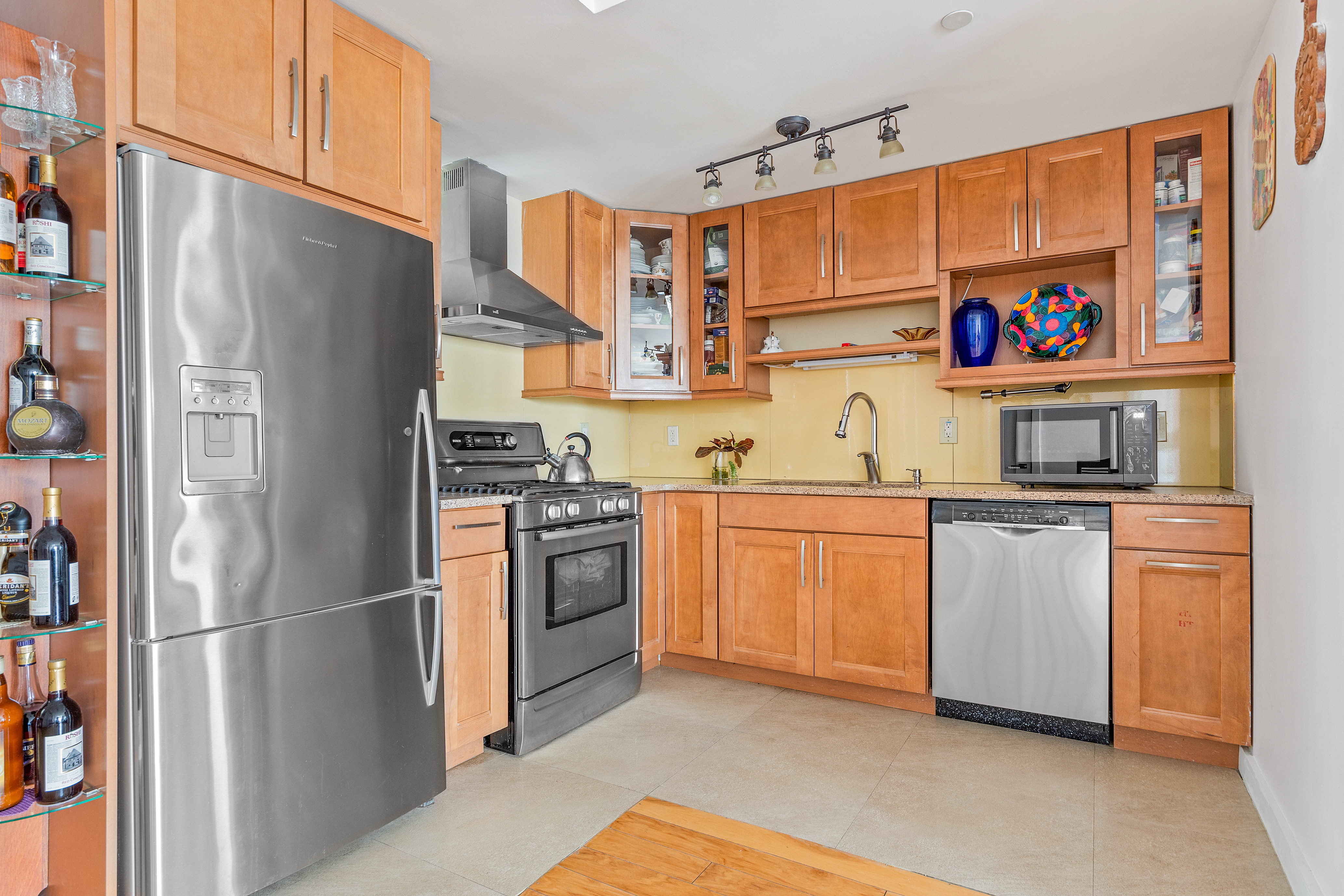 62 Brighton 2nd Place, Unit 4B Brooklyn, NY 11235 - Photo 4 of 12 a kitchen with stainless steel appliances granite countertop a refrigerator and a stove
