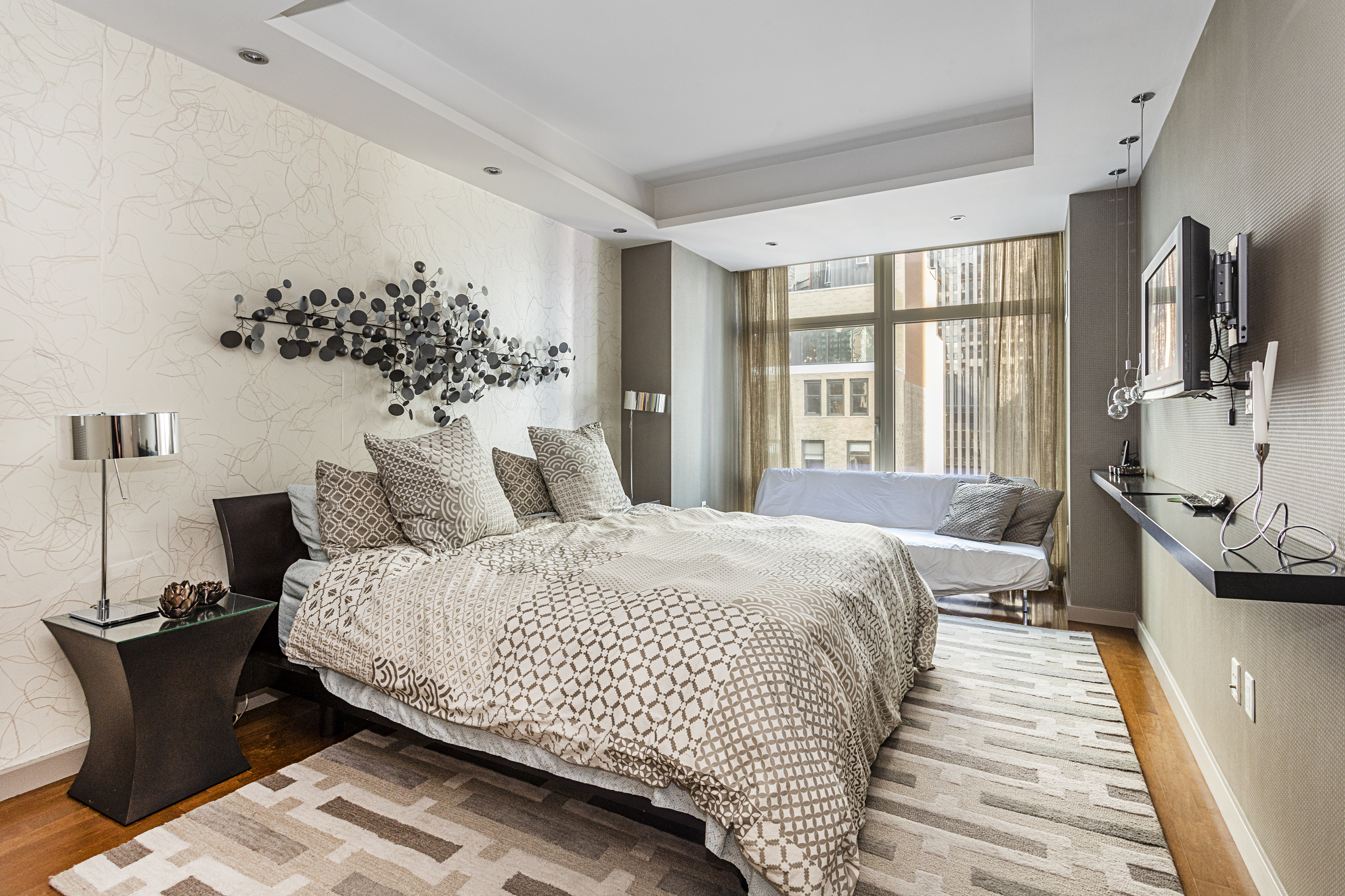 1600 Broadway, Unit 18G Manhattan, NY 10019 - Photo 5 of 10 a bedroom with bed and wooden floor