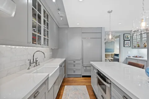a kitchen with a sink stove and refrigerator