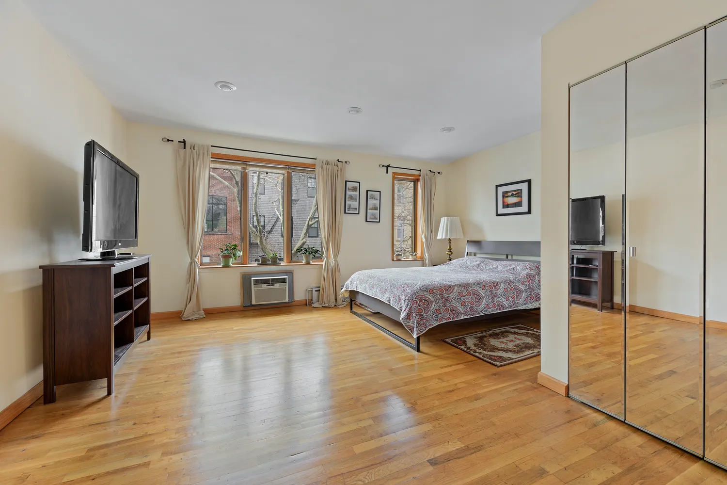 a bedroom with a bed and a view of kitchen