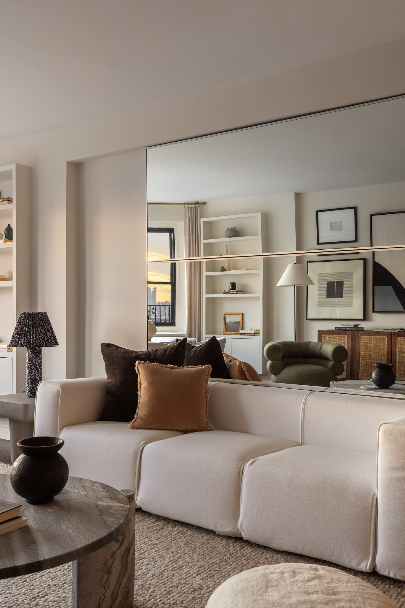 31 Jane Street, Unit 16G Manhattan, NY 10014 - Photo 2 of 20 a living room with furniture and a lamp