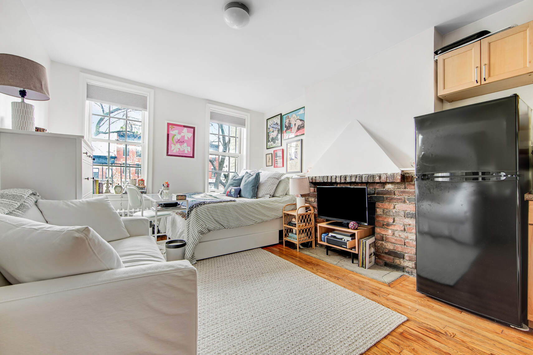 352 West 12th Street, Unit 5D Manhattan, NY 10014 - Photo 5 of 11 a living room with furniture and a flat screen tv