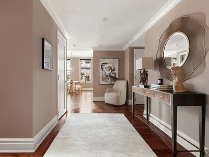 a kitchen with stainless steel appliances granite countertop a stove a sink dishwasher a dining table and chairs with wooden floor