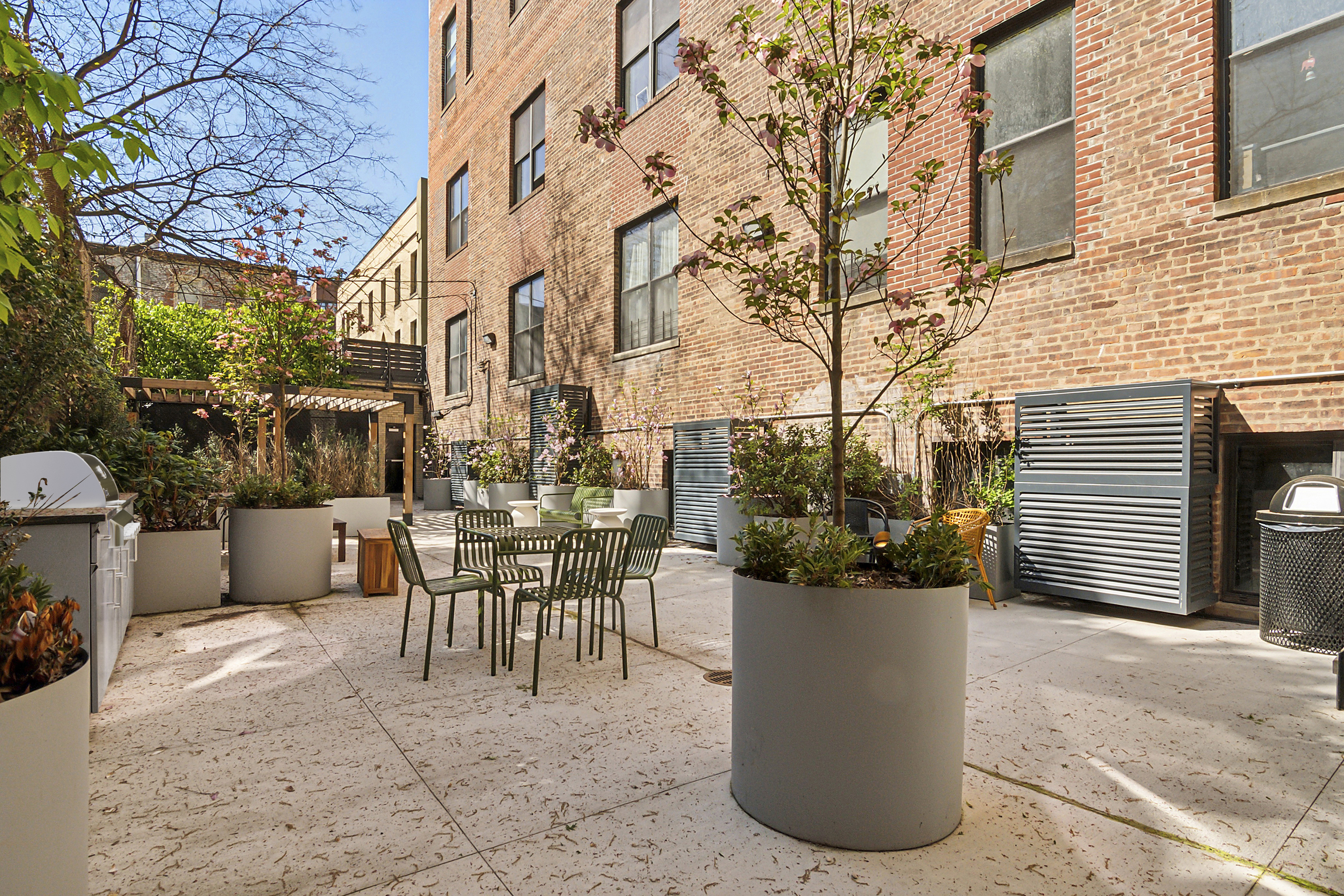 180 Bainbridge Street, Unit 111 Brooklyn, NY 11233 - Photo 7 of 25 a view of a patio with table and chairs and potted plants