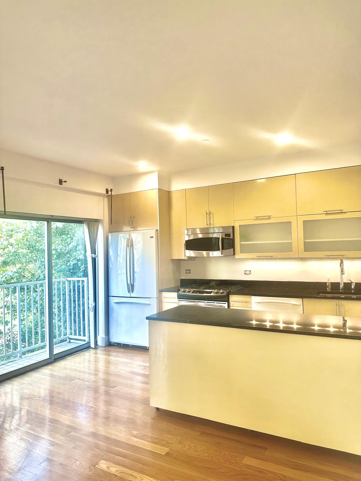 221 West 148th Street, Unit 4A Manhattan, NY 10039 - Photo 5 of 11 a view of a kitchen with a large window