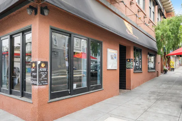 a storage room with stainless steel appliances granite countertop a sink and cabinets