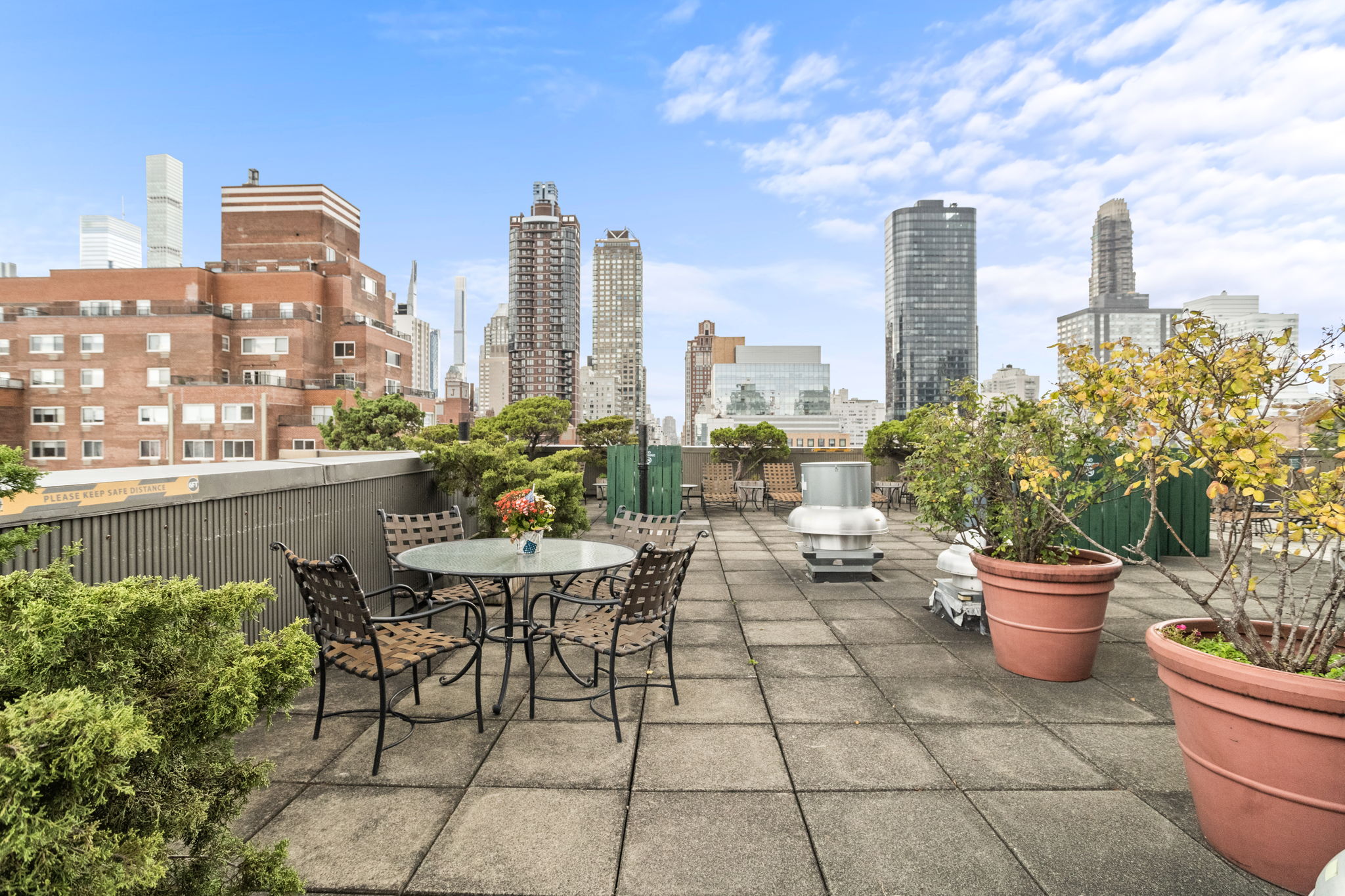 401 East 65th Street, Unit 12F Manhattan, NY 10065 - Photo 11 of 18 a view of a terrace with chairs and a potted plant