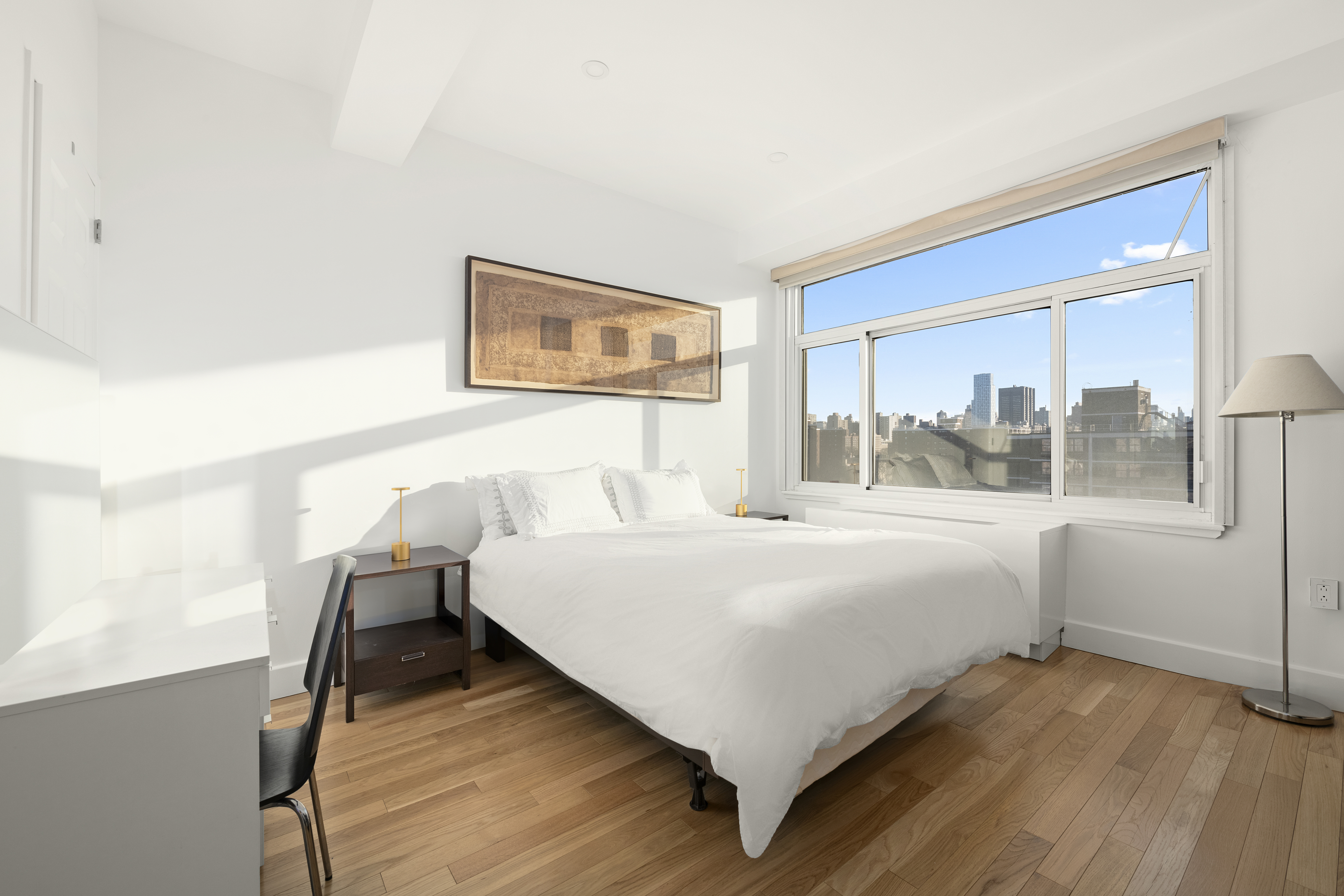 106 West 116th Street, Unit 10B Manhattan, NY 10026 - Photo 8 of 12 a bedroom with a bed and window