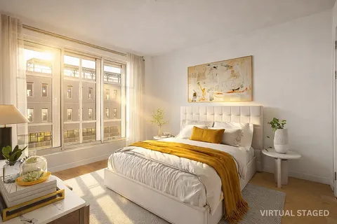 a bedroom with a bed and glass window