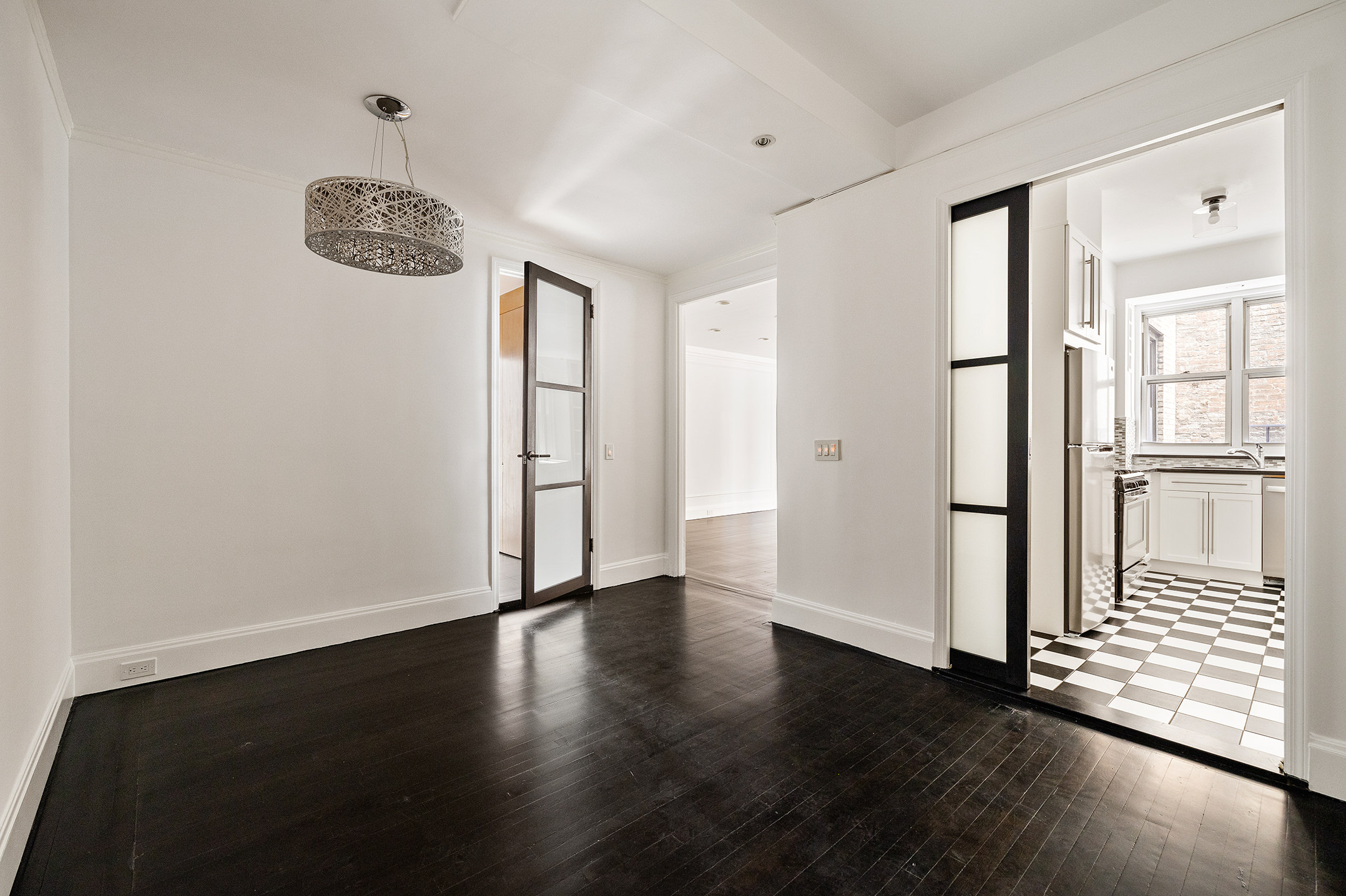 310 West End Avenue, Unit 2A Manhattan, NY 10023 - Photo 7 of 19 an empty room with wooden floor and windows