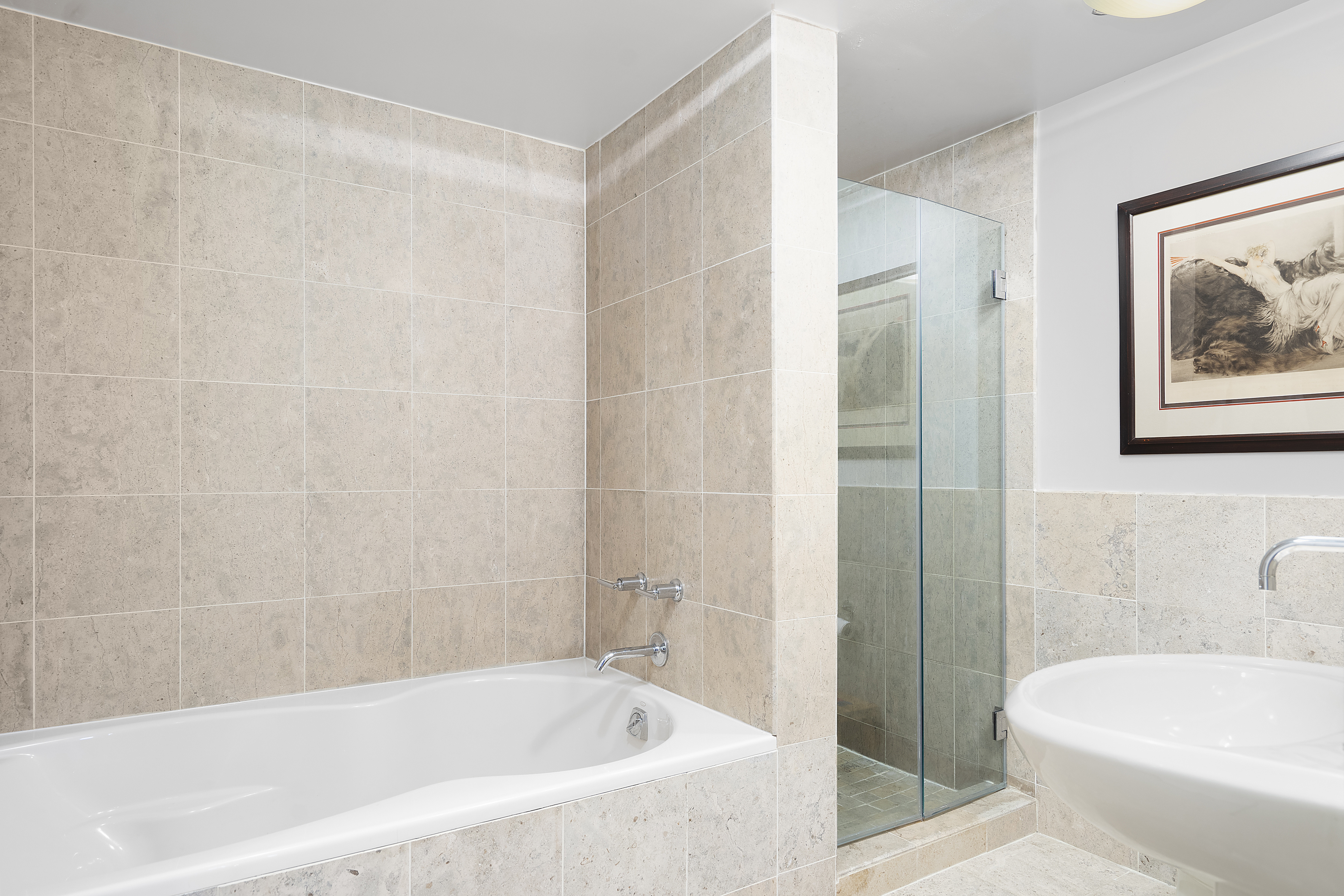 1485 5th Avenue, Unit 18/19H Manhattan, NY 10035 - Photo 9 of 21 a white bath tub sitting next to a white toilet