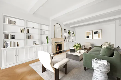 a living room with furniture fireplace and a window