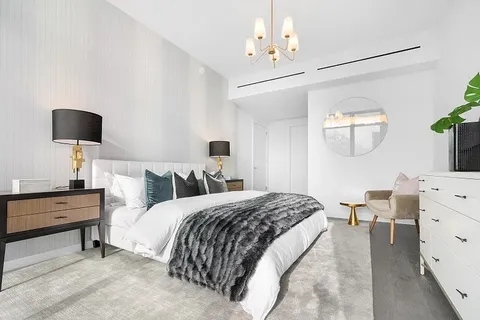 a living room with furniture and a wall painting