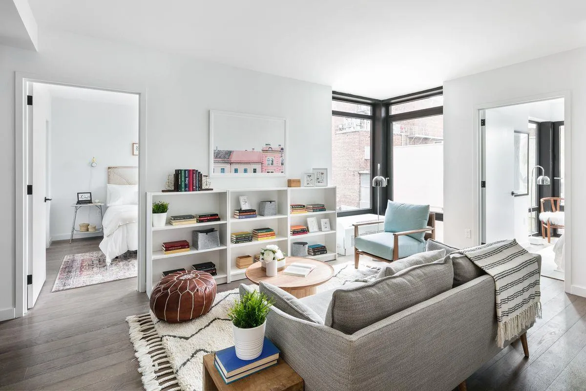 a living room with furniture and a book shelf