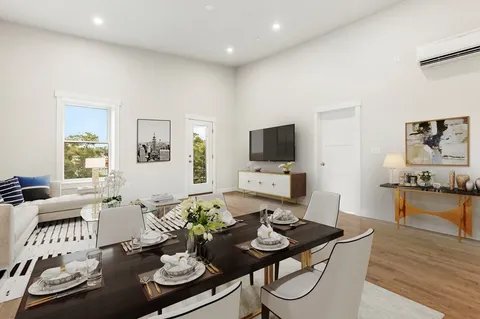 a living room with furniture and wooden floor