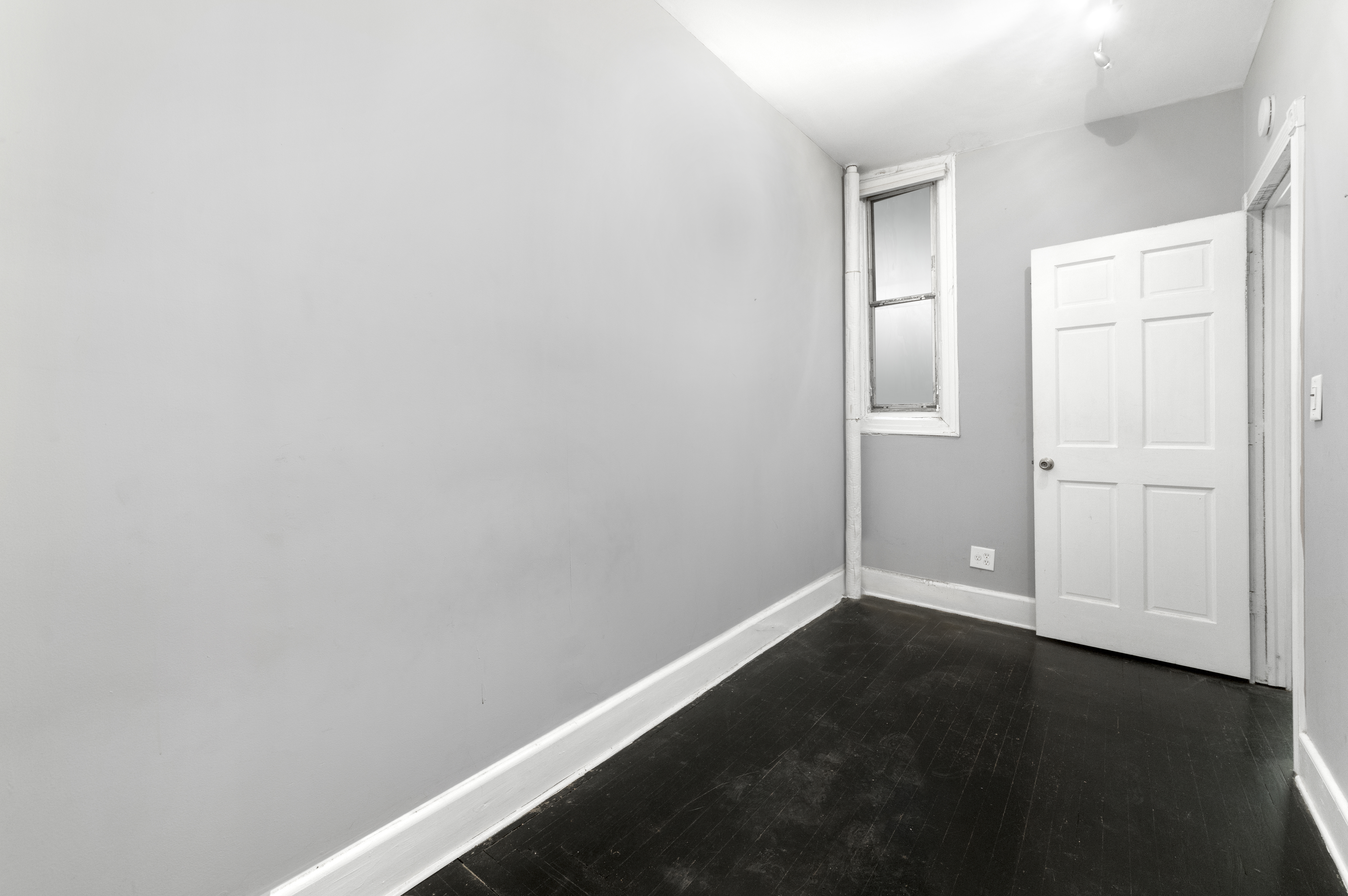 1605 York Avenue, Unit 1A Manhattan, NY 10028 - Photo 6 of 8 an empty room with wooden floor