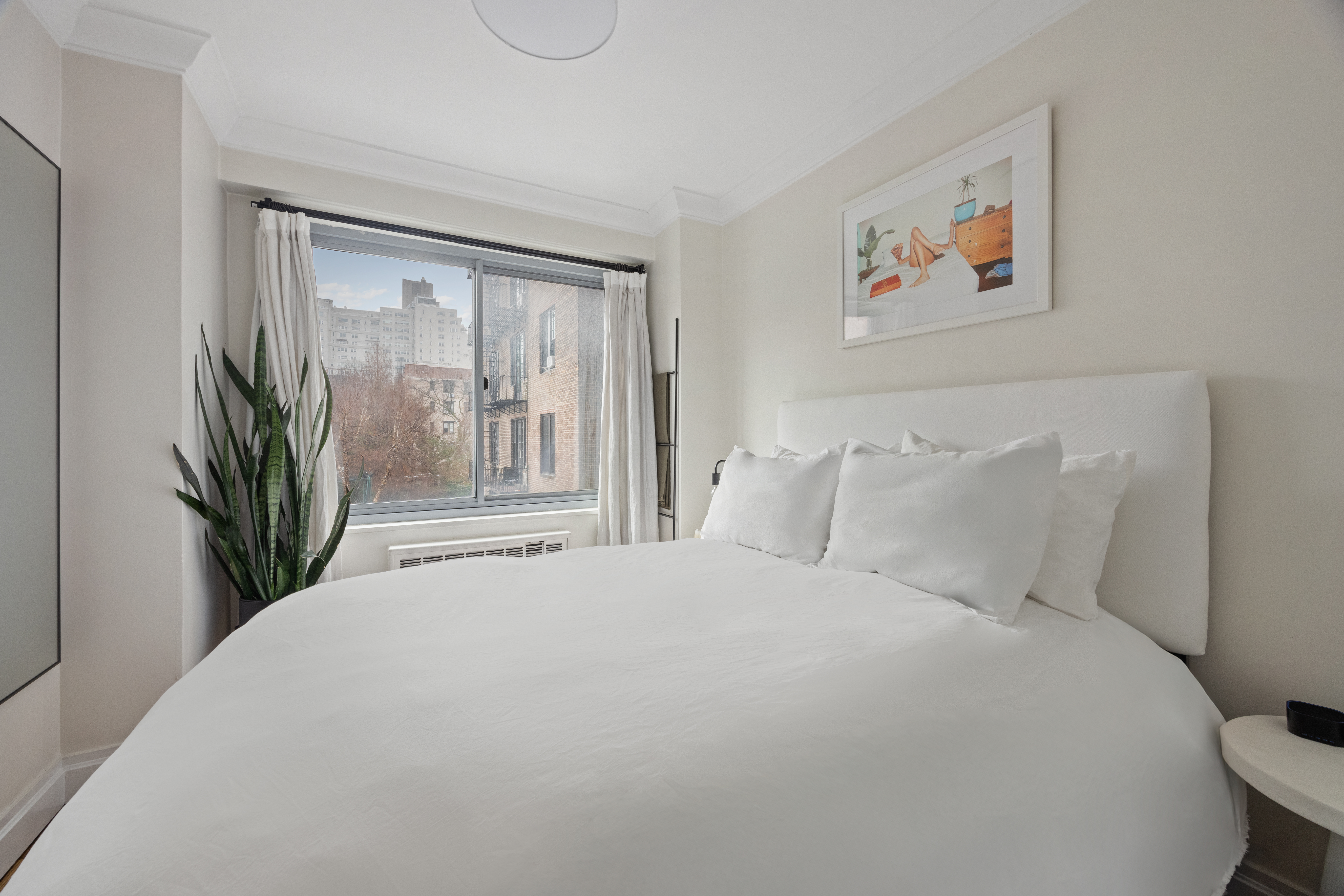 175 West 12th Street, Unit 4L Manhattan, NY 10011 - Photo 9 of 11 a bedroom with a large bed and a painting on the wall