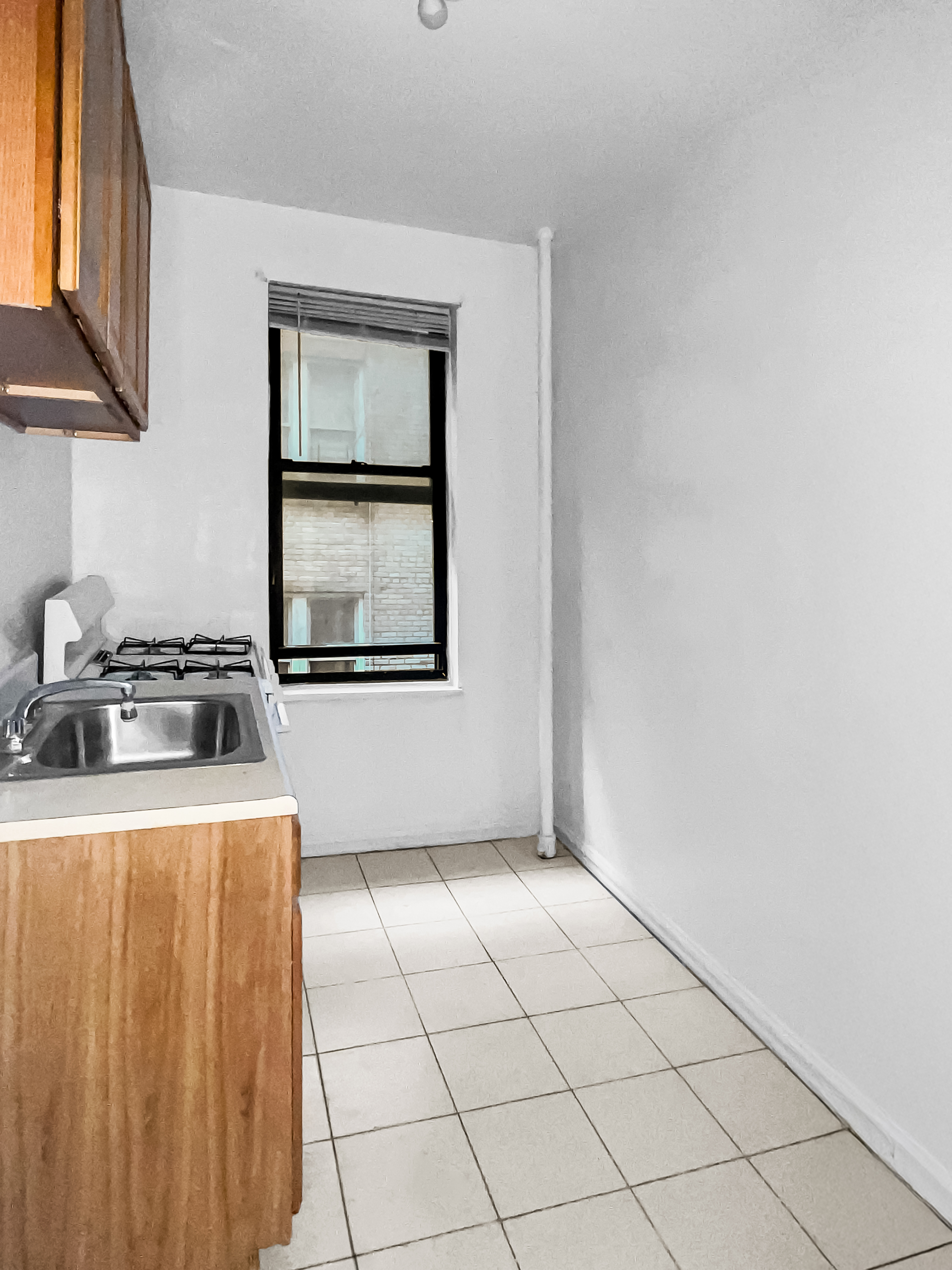 2776 Jerome Avenue, Unit 3C Bronx, NY 10468 - Photo 6 of 8 a kitchen with a stove top oven and cabinets