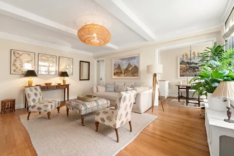 a living room with furniture a dining table and a large window with garden view