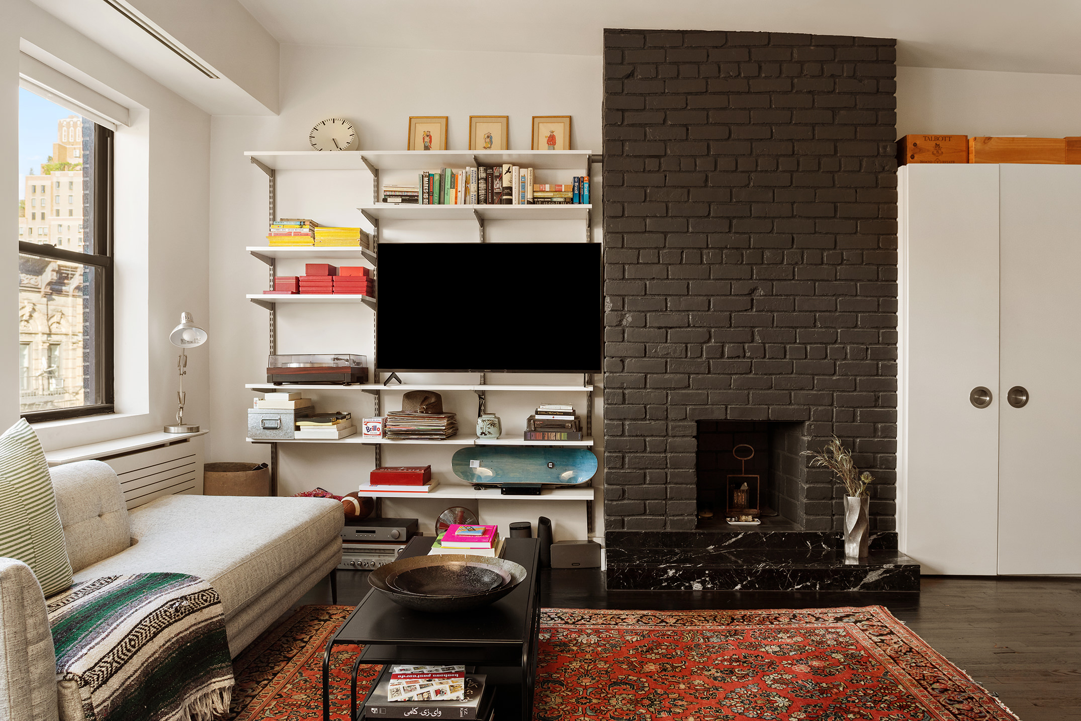 250 West 15th Street, Unit PH6E Manhattan, NY 10011 - Photo 4 of 9 a living room with furniture and a fireplace