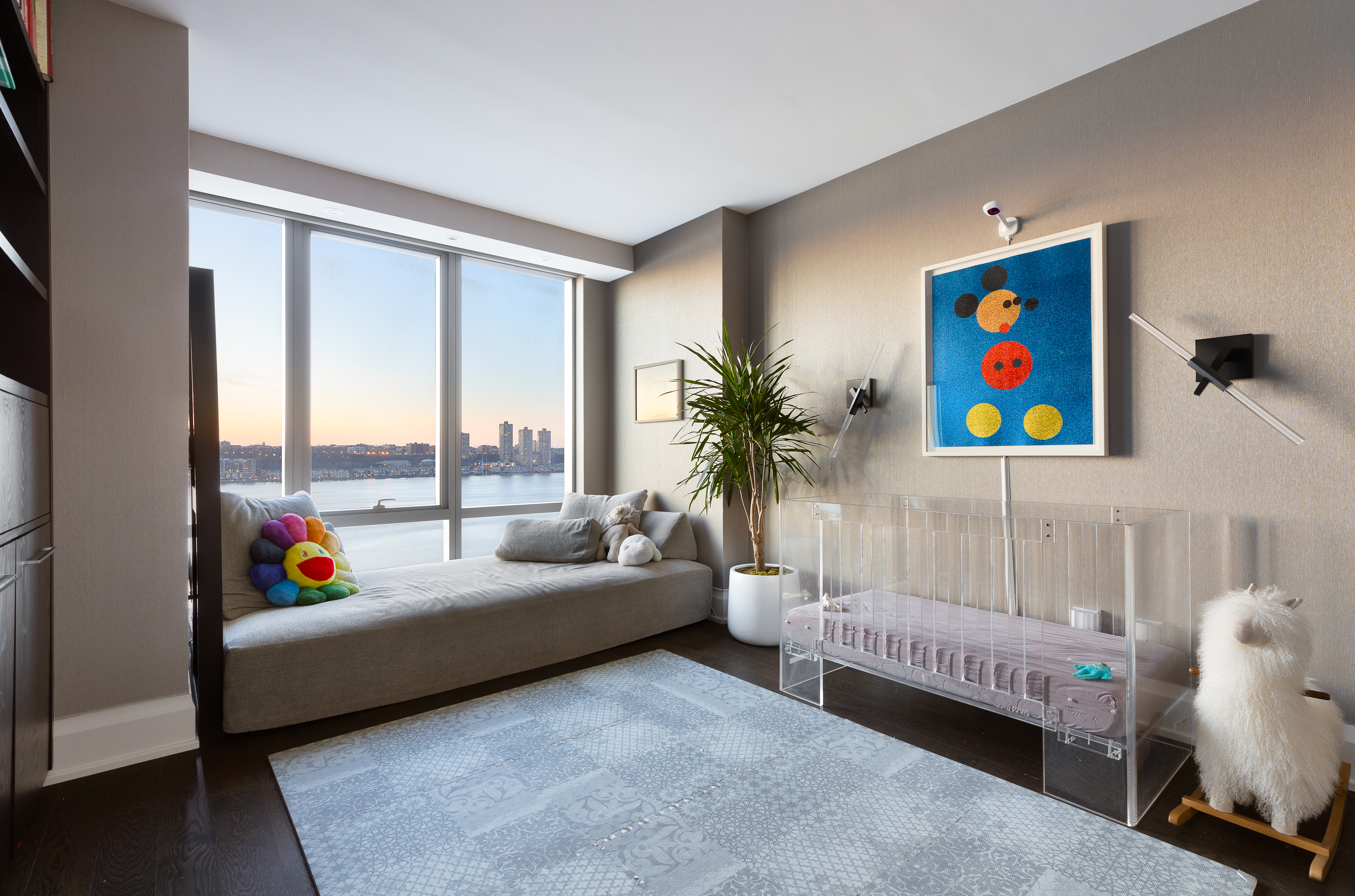 50 Riverside Boulevard, Unit 14L Manhattan, NY 10069 - Photo 8 of 22 a living room with furniture and a potted plant