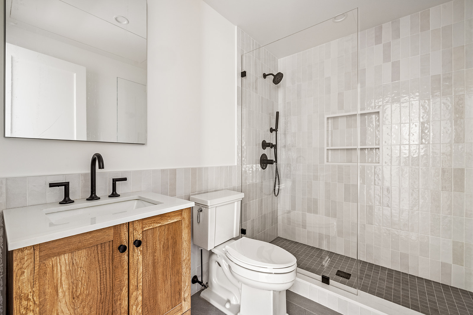 119 Henry Street, Unit 3 Brooklyn, NY 11201 - Photo 11 of 14 a bathroom with a granite countertop sink toilet and shower