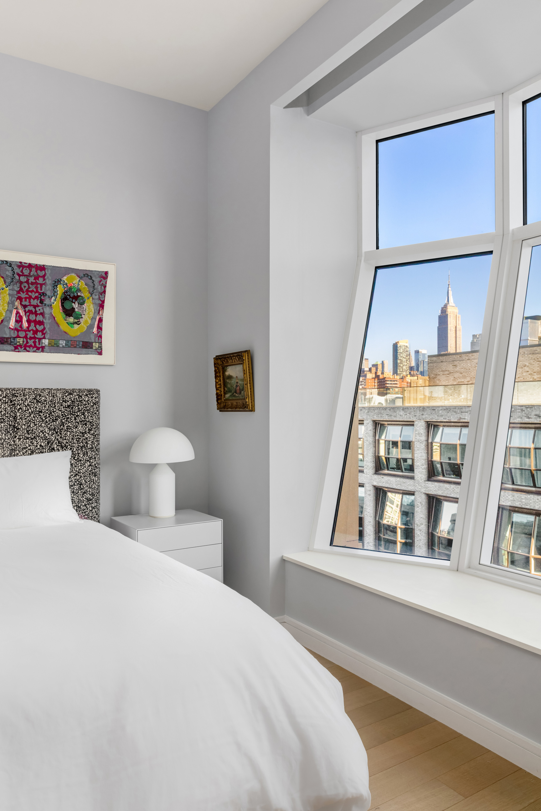 515 West 18th Street, Unit 1102 Manhattan, NY 10011 - Photo 9 of 18 a bedroom with a bed and a large window