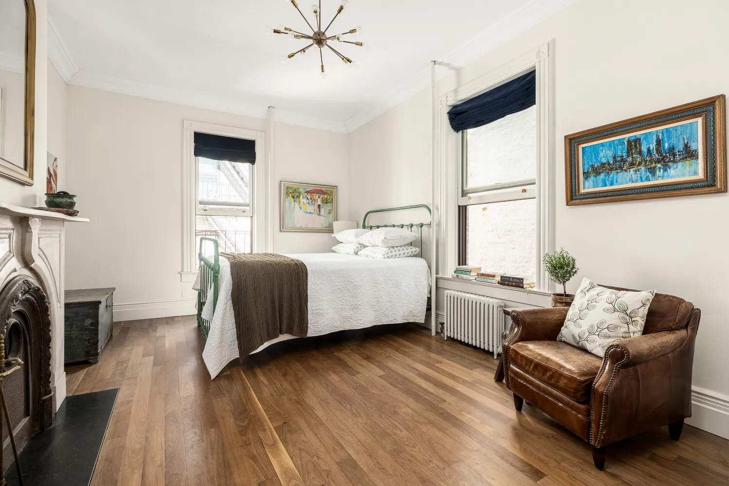 a spacious bedroom with a bed couch and a window