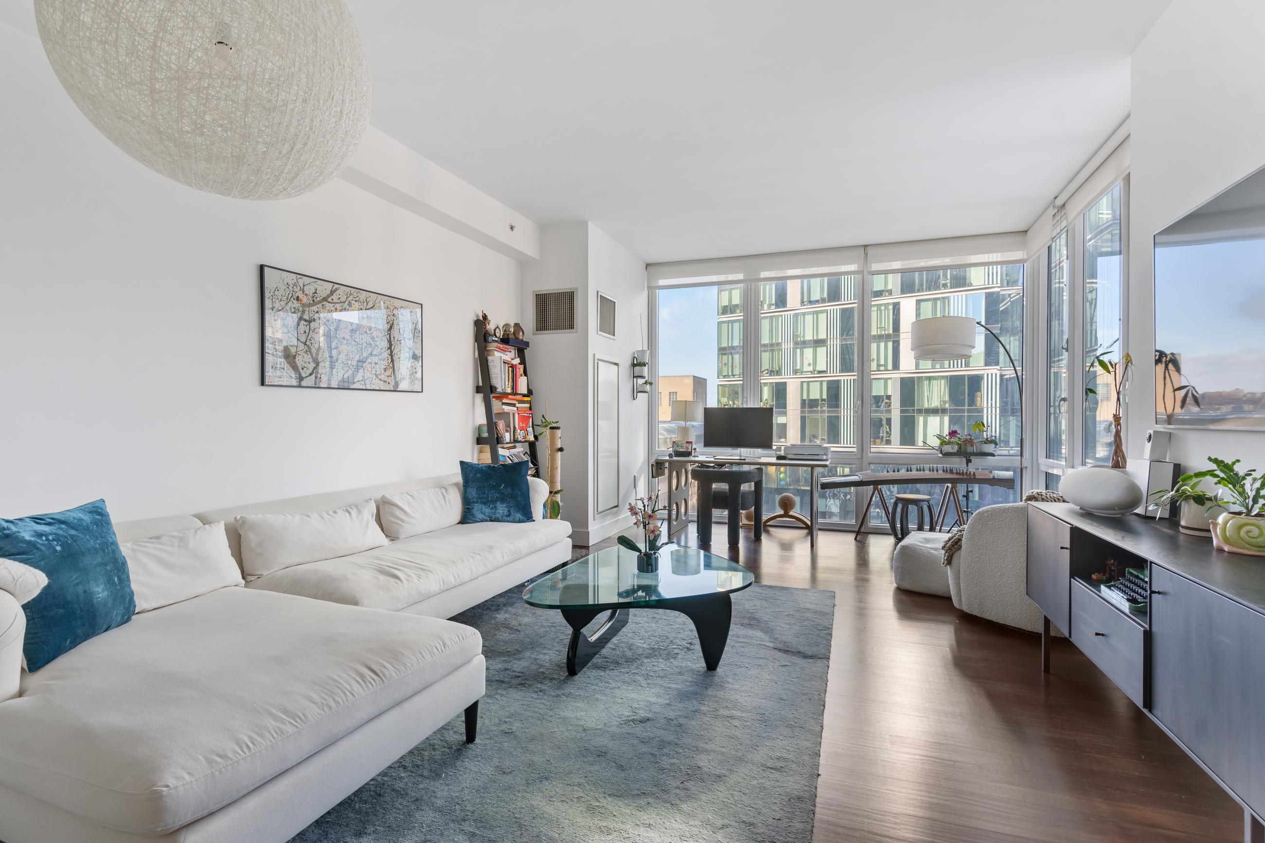 10 West End Avenue, Unit 11G Manhattan, NY 10023 - Photo 3 of 9 a living room with furniture and a large window