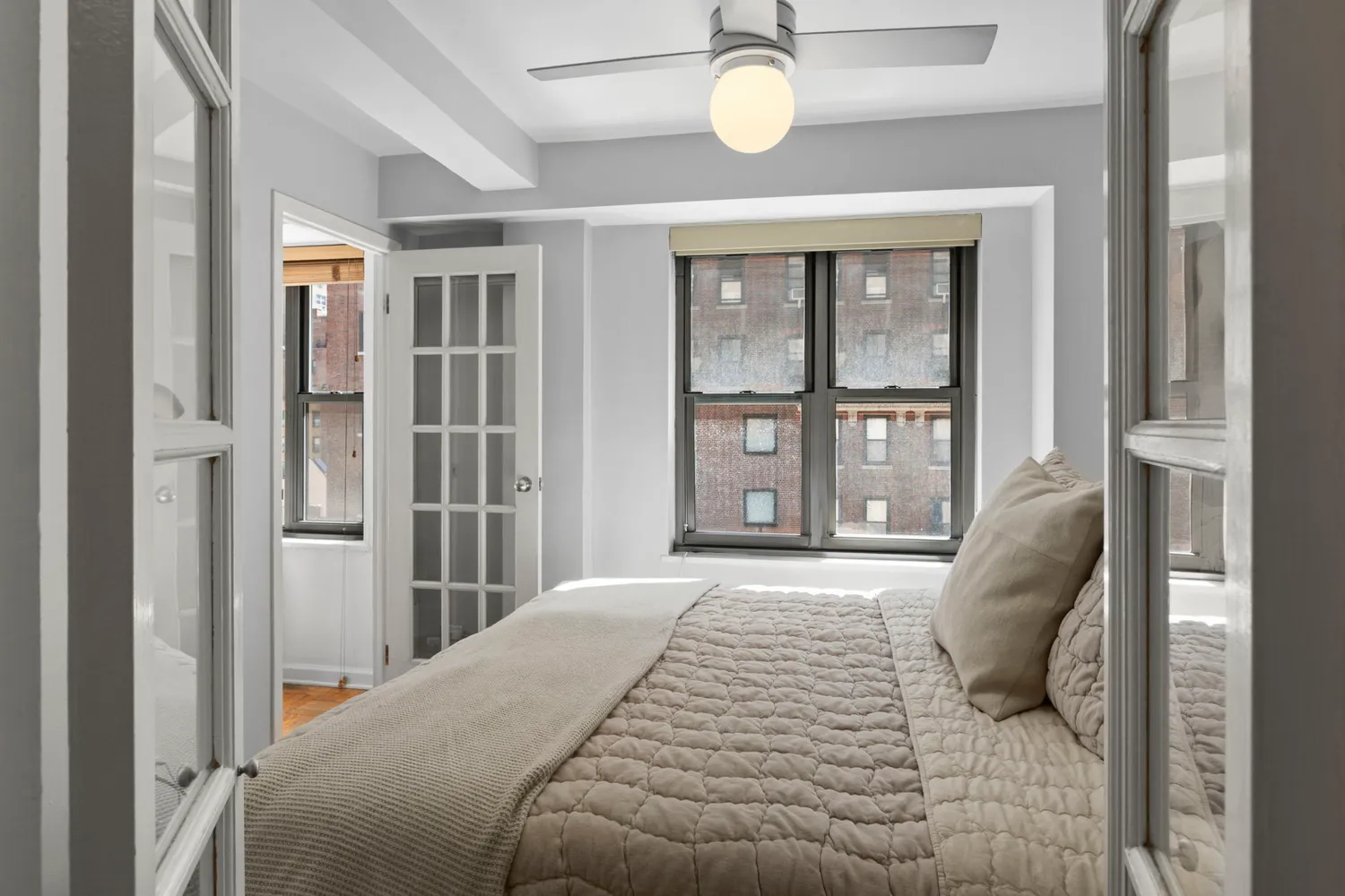 a bedroom with a bed and glass door