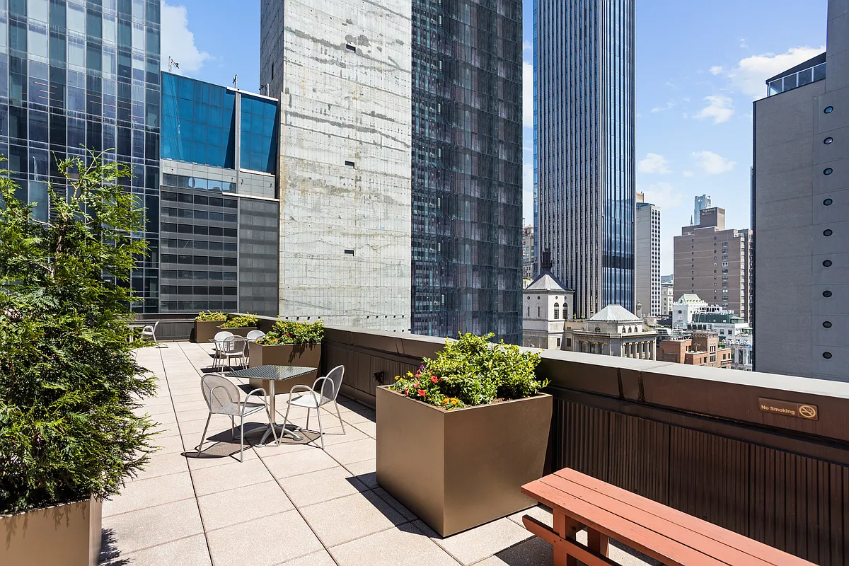 146 West 57th Street, Unit 47B Manhattan, NY 10019 - Photo 11 of 15 a view of a patio with couches and potted plants