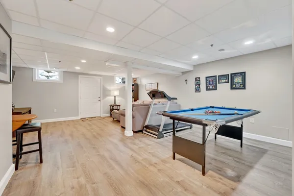 a living room with furniture a table and kitchen view
