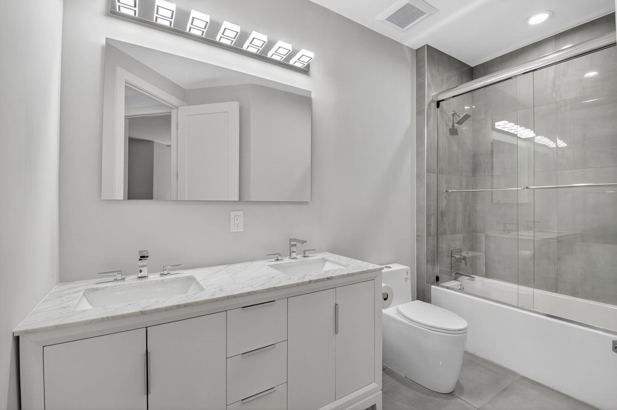6529 Somerset Circle Boca Raton, FL 33496 - Photo 32 of 75 a bathroom with a double vanity sink mirror and toilet