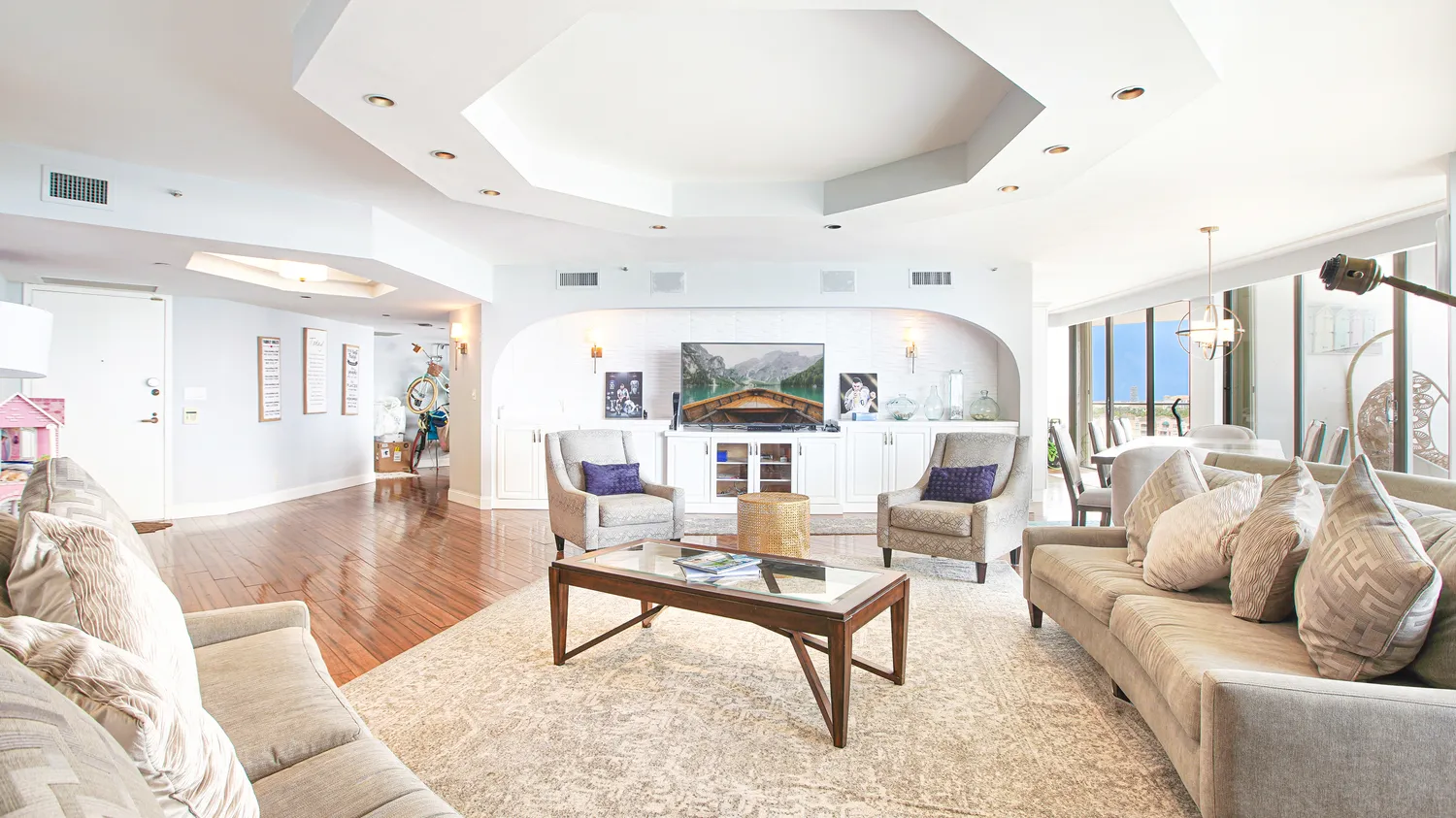 a living room with furniture and wooden floor