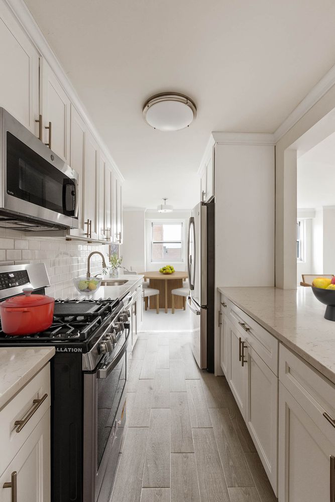 a kitchen with stainless steel appliances granite countertop a stove sink and cabinets