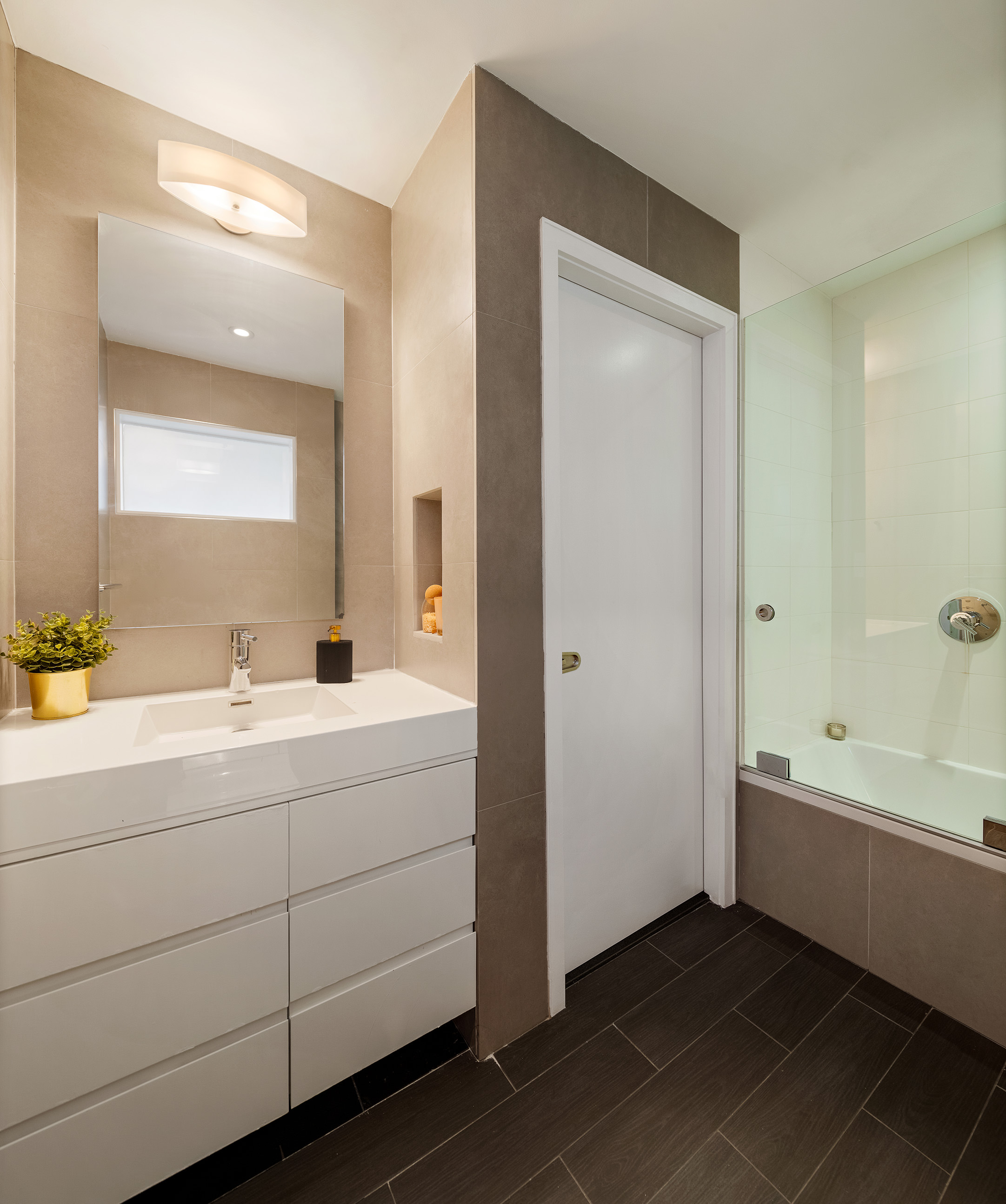 142 5th Avenue, Unit 2 Manhattan, NY 10011 - Photo 9 of 18 a bathroom with a bathtub a sink and a mirror