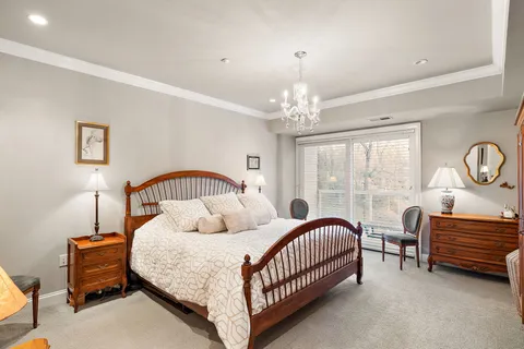 a bedroom with a bed and a chandelier