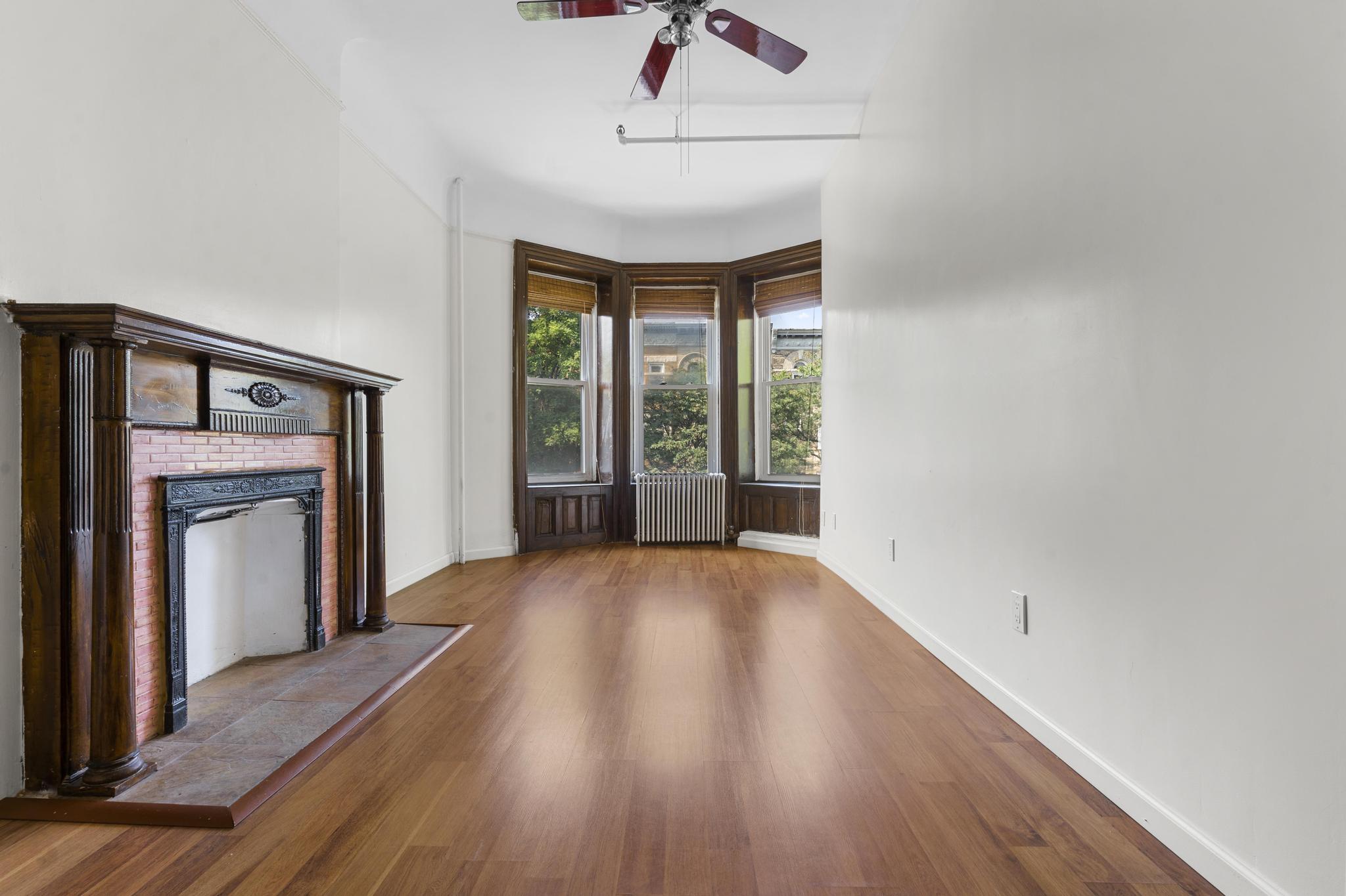 880 Park Place, Unit 2 Brooklyn, NY 11216 - Photo 4 of 12 a view of an empty room with a window and wooden floor
