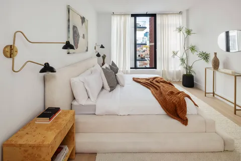 a bedroom with a bed and window