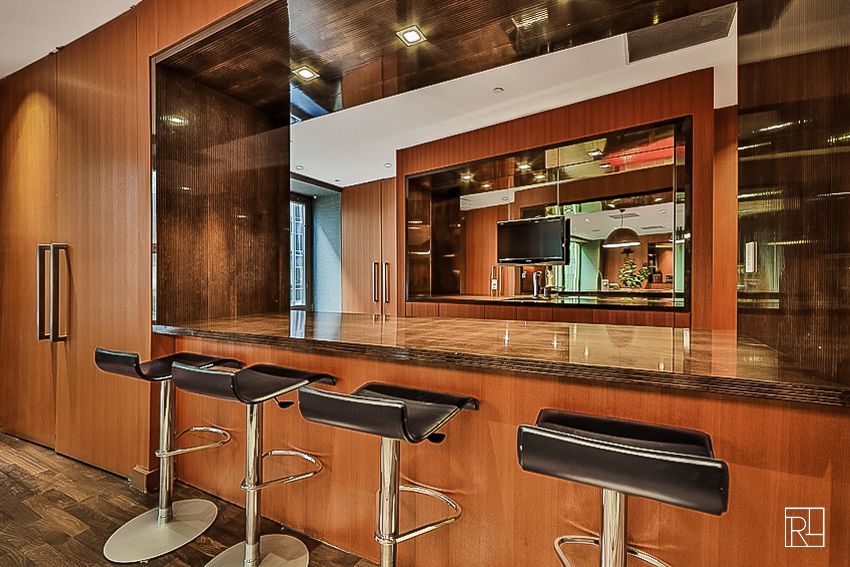 75 Wall Street, Unit 28D Manhattan, NY 10005 - Photo 23 of 35 a kitchen with a table and chairs in it