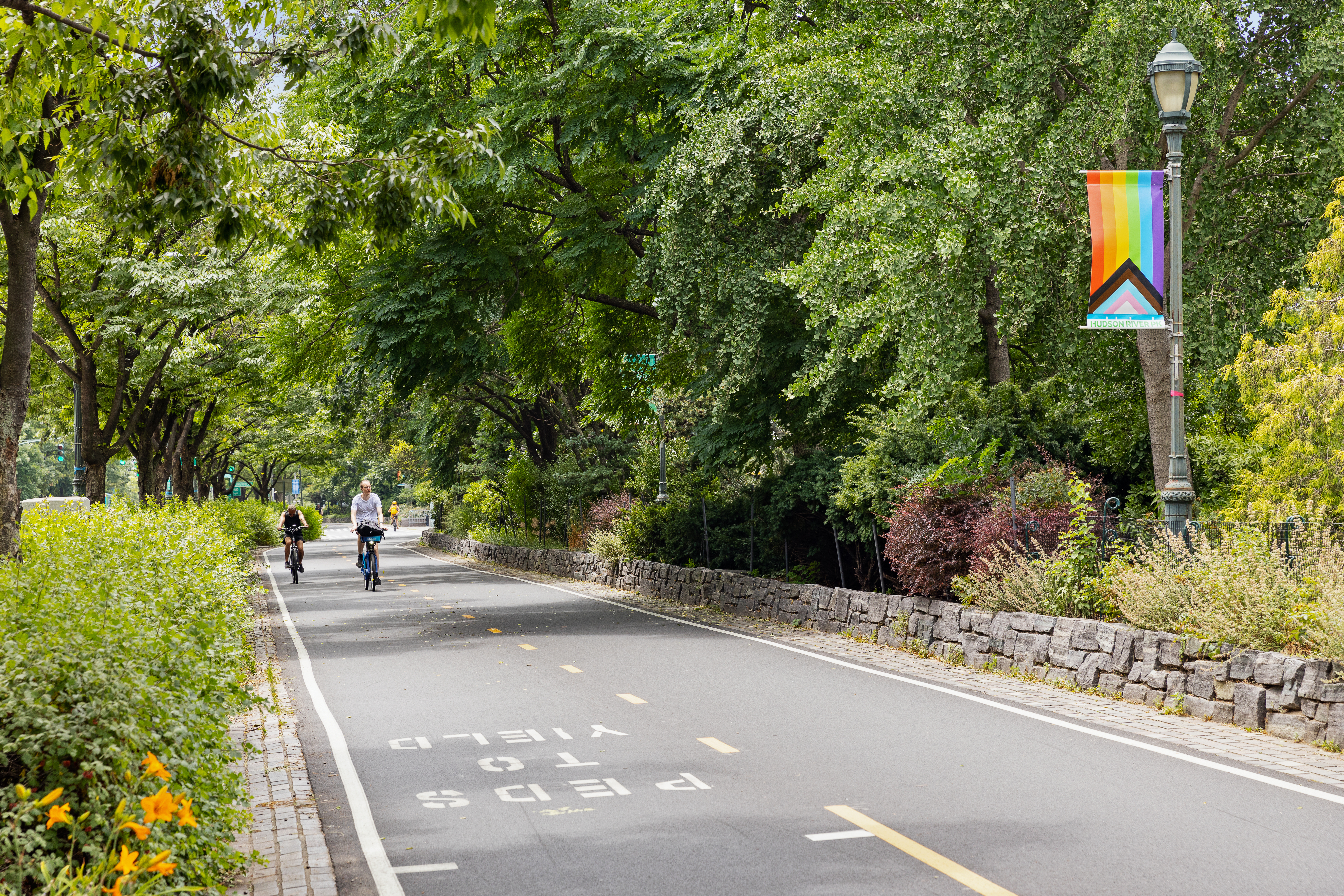 167 Perry Street, Unit 4K Manhattan, NY 10014 - Photo 10 of 11 a view of a street with potted plants and large trees