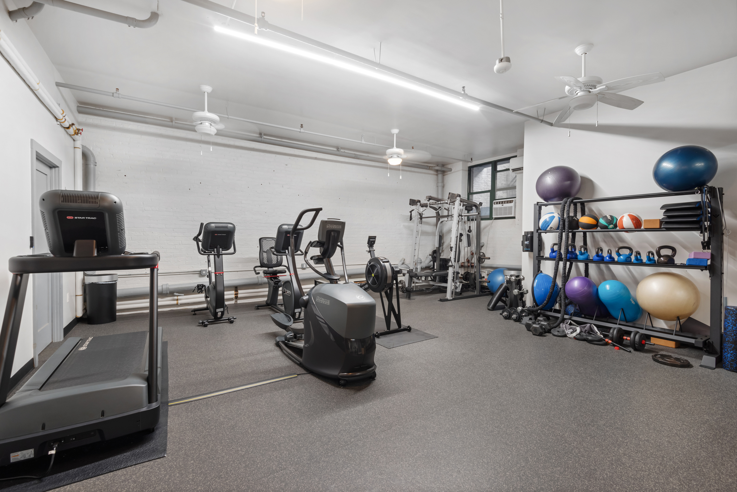 105 Lexington Avenue, Unit 2G Brooklyn, NY 11238 - Photo 14 of 17 a room with gym equipment and a large window