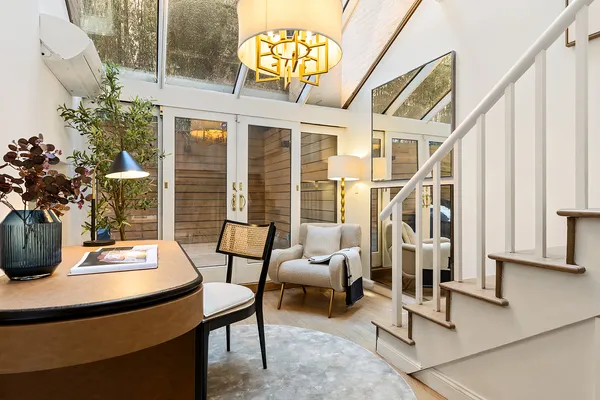 a living room with furniture and a potted plant