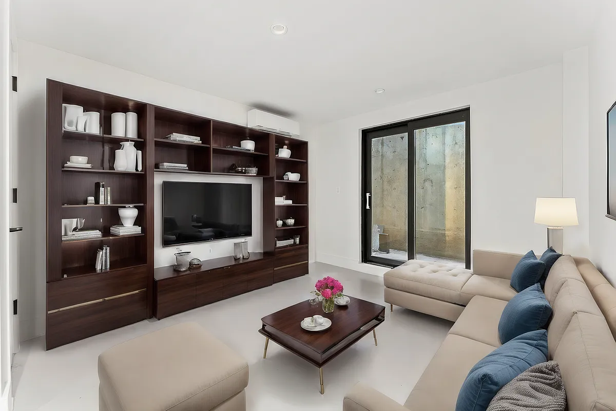 30 Belvidere Street, Unit 1B Brooklyn, NY 11206 - Photo 2 of 6 a living room with furniture and a flat screen tv